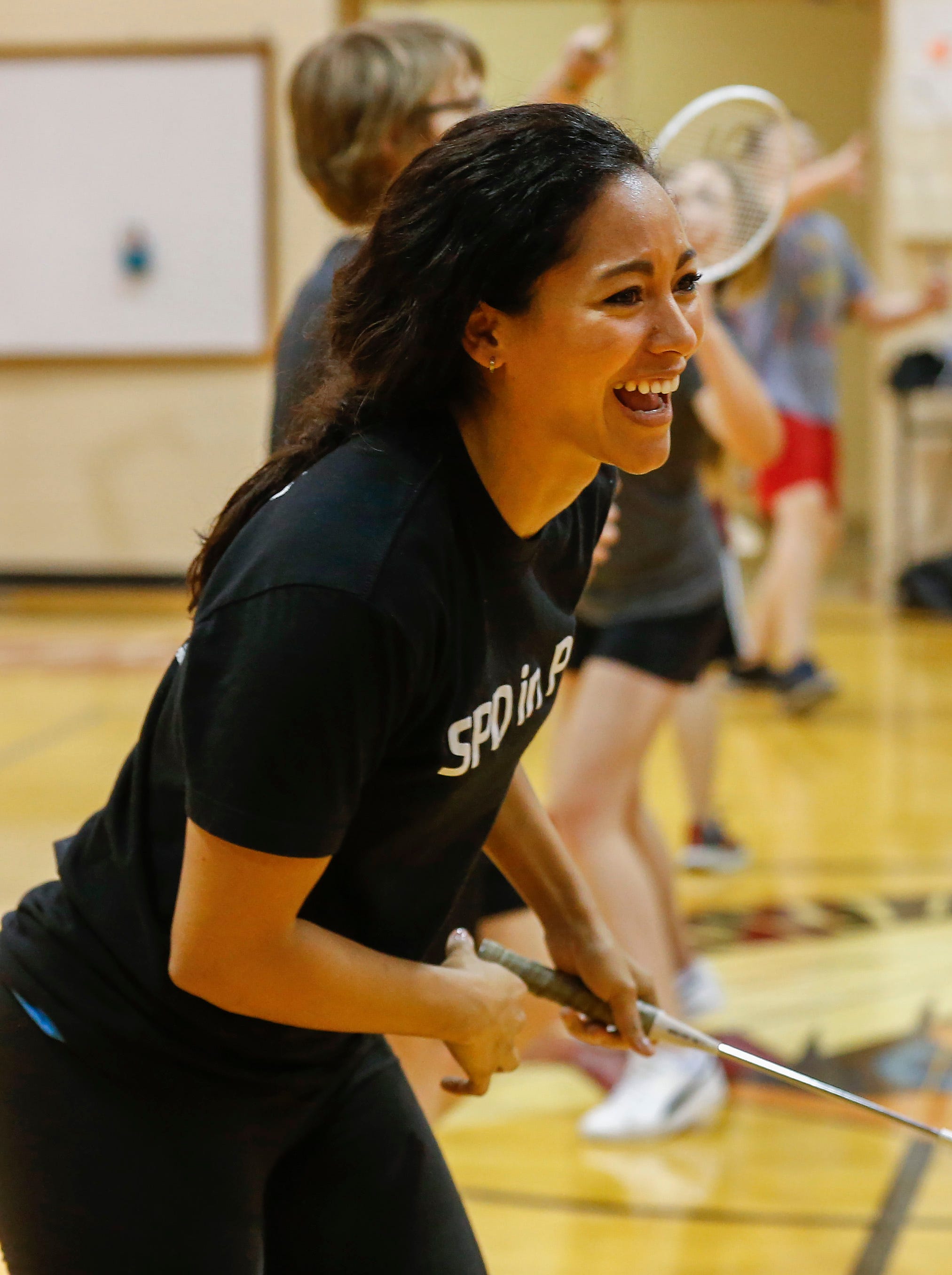 Springfield Police Department Public Information Officer Jasmine Bailey laughs as she plays badminton with seventh-grade students at Cherokee Middle School as part of the SPD in PE program on Wednesday, Oct. 16, 2019.