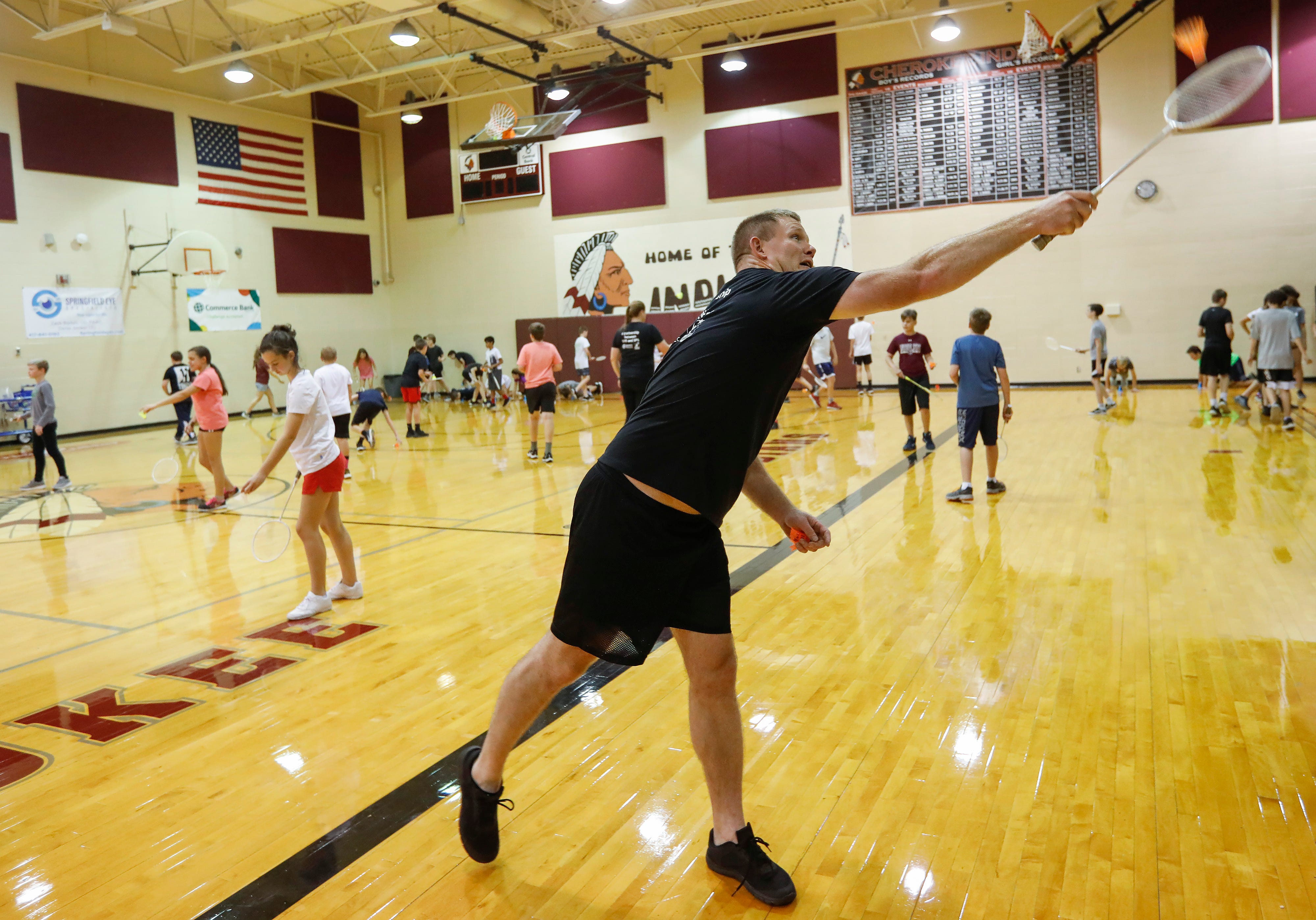 Springfield Police Officer Aaron Cottengim plays badminton with seventh-grade students at Cherokee Middle School as part of the SPD in PE program on Wednesday, Oct. 16, 2019.