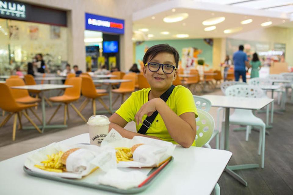 ″This kind of lifestyle causes diseases like liver cancer, I think,″ said 10-year-old Yerzhan, posing with his usual fast-food lunch — two hamburgers with fries and a milkshake — In Almaty, Kazakhstan.