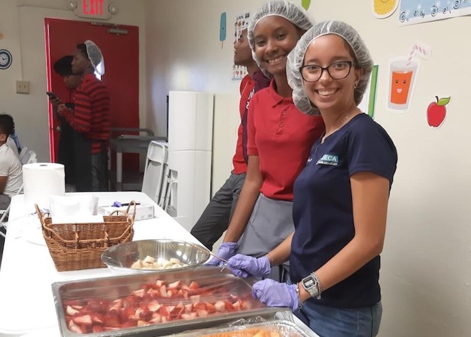 Kids at the Boys & Girls Clubs of Puerto Rico take turns helping out in the kitchen and serving food to their peers.