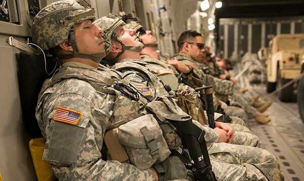 Army National Guard soldiers catch a few minutes of sleep on board a C-17 Globemaster. (Heide Couch/Air Force)