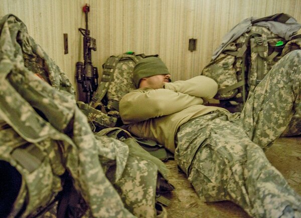 Sgt. Ryan Blount, 27th Brigade, New York Army National Guard, rests in a hallway after a full day of field training, before heading back out Jan. 16, 2015, at Alexandria International Airport, La. (Air Force)