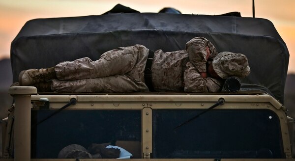 Sgt. Daniel Arivett, Headquarters and Service Company, 1st Battalion, 3rd Marines, sleeps on the roof of a vehicle during Integrated Training Exercise 2-17 at Marine Corps Air Ground Combat Center, Twentynine Palms, California, on Feb. 16, 2017. (Marine Corps)
