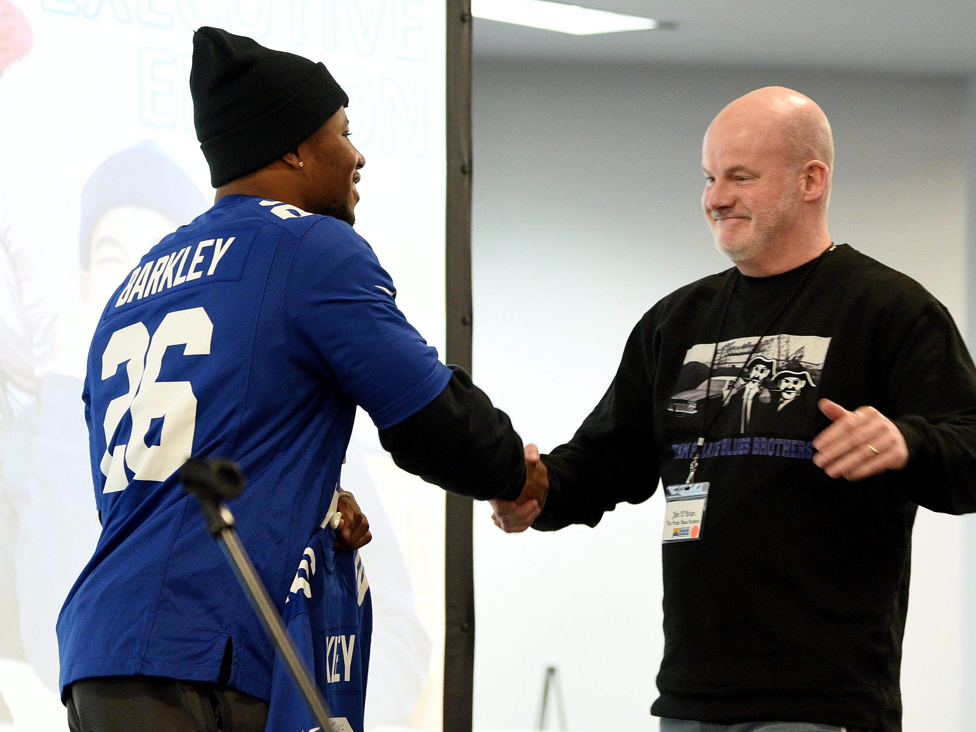 Covenant House holds a Sleep Out Executive Edition in Newark on Thursday November 21, 2019. Saquon Barkley a player with the Giants and Sleep Out: Executive Edition Chairman shakes the hand of the top fundraiser Jim O'Brien.