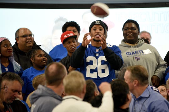 Covenant House holds a Sleep Out Executive Edition in Newark on Thursday November 21, 2019. Covenant House kids and fundraisers prepare to take a photo with Saquon Barkley a player with the Giants and Sleep Out: Executive Edition Chairman.