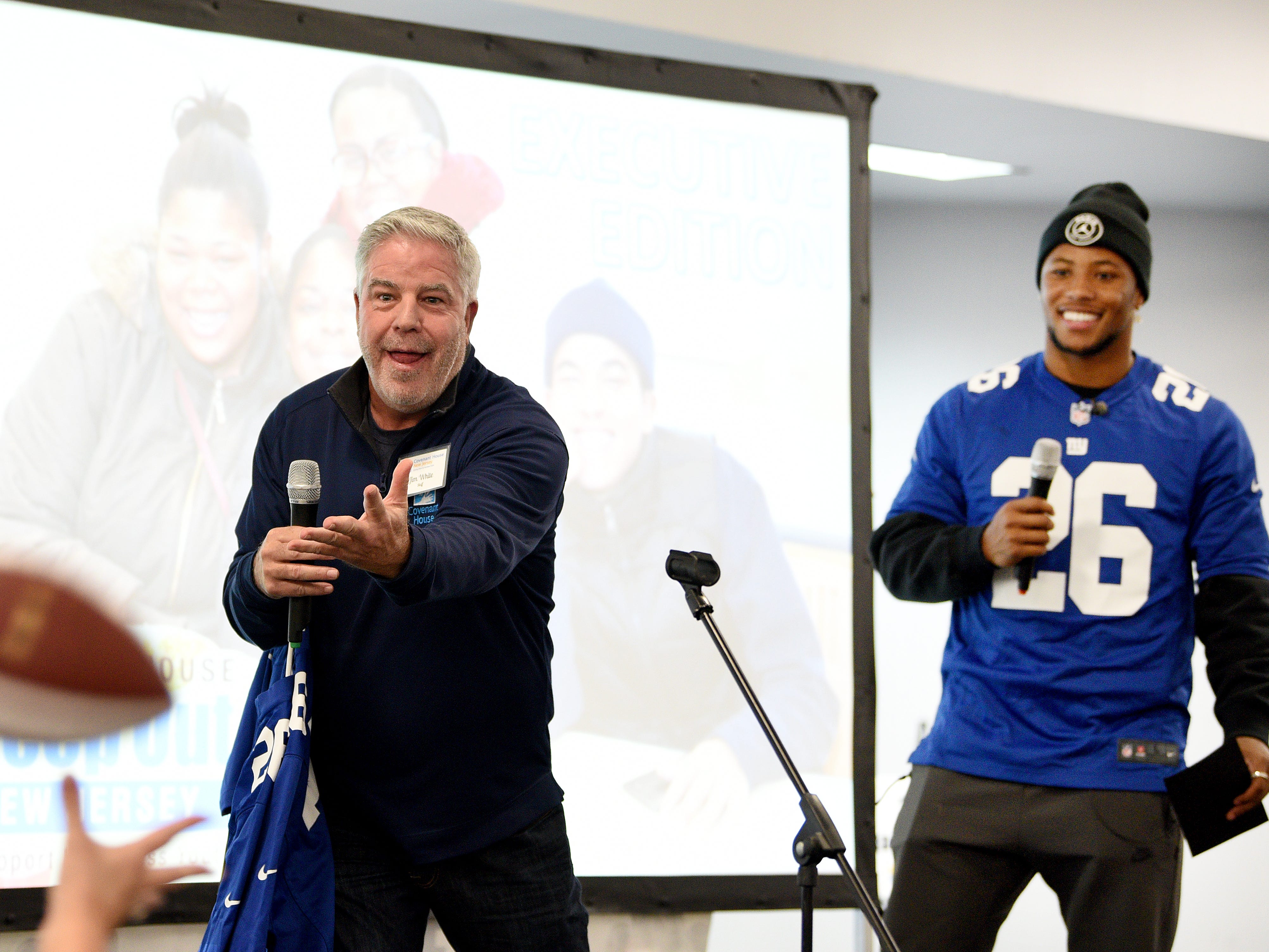 Covenant House holds a Sleep Out Executive Edition in Newark on Thursday November 21, 2019. Jim White tosses a football while Saquon Barkley a player with the Giants and Sleep Out: Executive Edition Chairman has a laugh. 