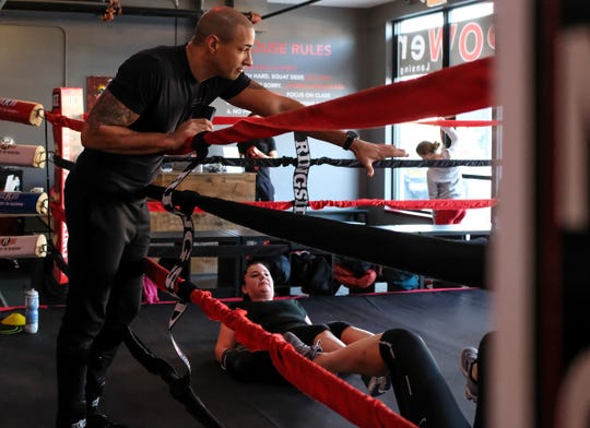 Brian Daniels, co-owner of the EmPOWer gym on Michigan Avenue in Lansing, encourages his students during a warm-up on Saturday, Nov. 23, 2019.