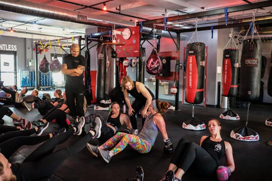 Brian Daniels and Leah Traciak-Zenker owners of EmPOWer gym on East Michigan Avenue in Lansing work with participants in their class on Saturday, Nov. 23, 2019.