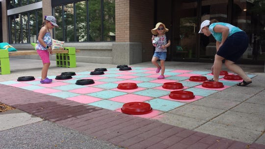 As part of the Building Active Communities Initiative, Get Fit volunteers transformed Davidson Plaza into a temporary active space which included a ping pong table, giant checkers, grass, plants and benches.