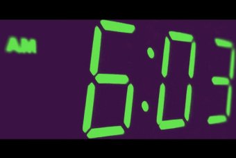 A digital clock face showing 6:03am.