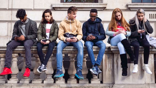 Teenagers using mobile phones