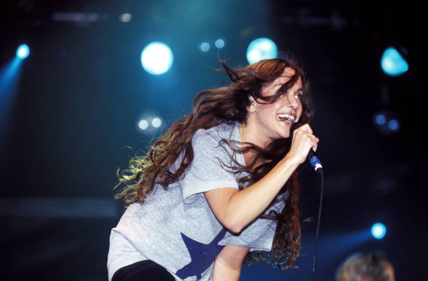 An early photo of Alanis Morissette performing at the T In The Park Festival in Scotland in 1996.