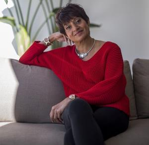a woman sitting on a couch: Dr Ramlakhan, pictured, shared her advice on the steps every parent can take to help their child sleep better at night, including creating a ritual and banning blue light from bedrooms