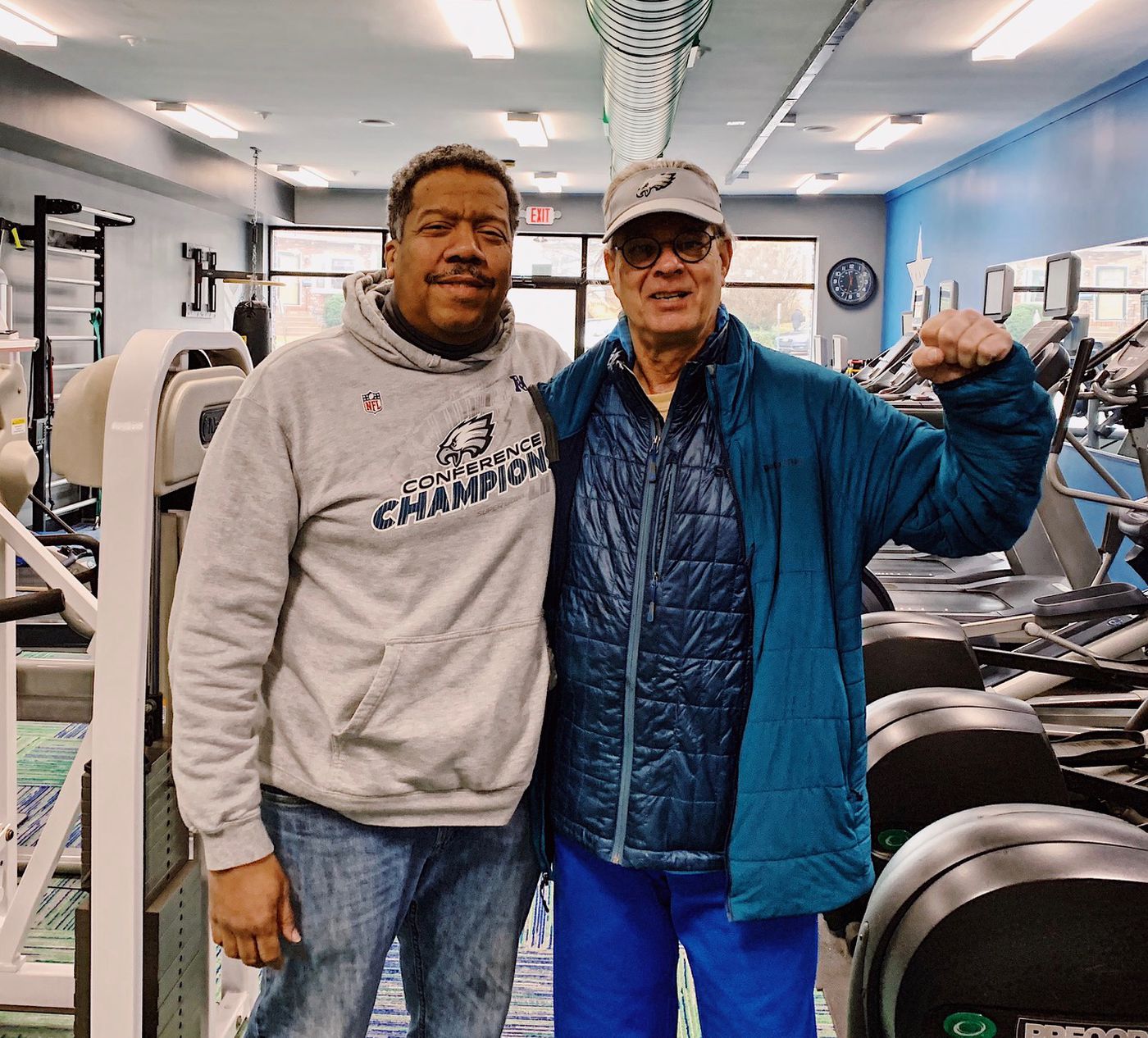 FItness trainer Lance Jones, left, with his high school track coach and biology teacher, Crawford Hill.