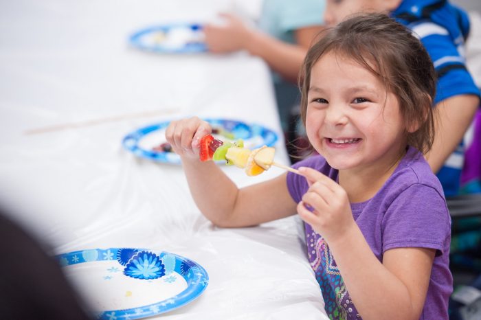 Children learn how to make fruit kebabs at the Spirit Lake Food Distribution Program located on the Spirit Lake reservation in North Dakota. (USDA photo by Don Hamilton)