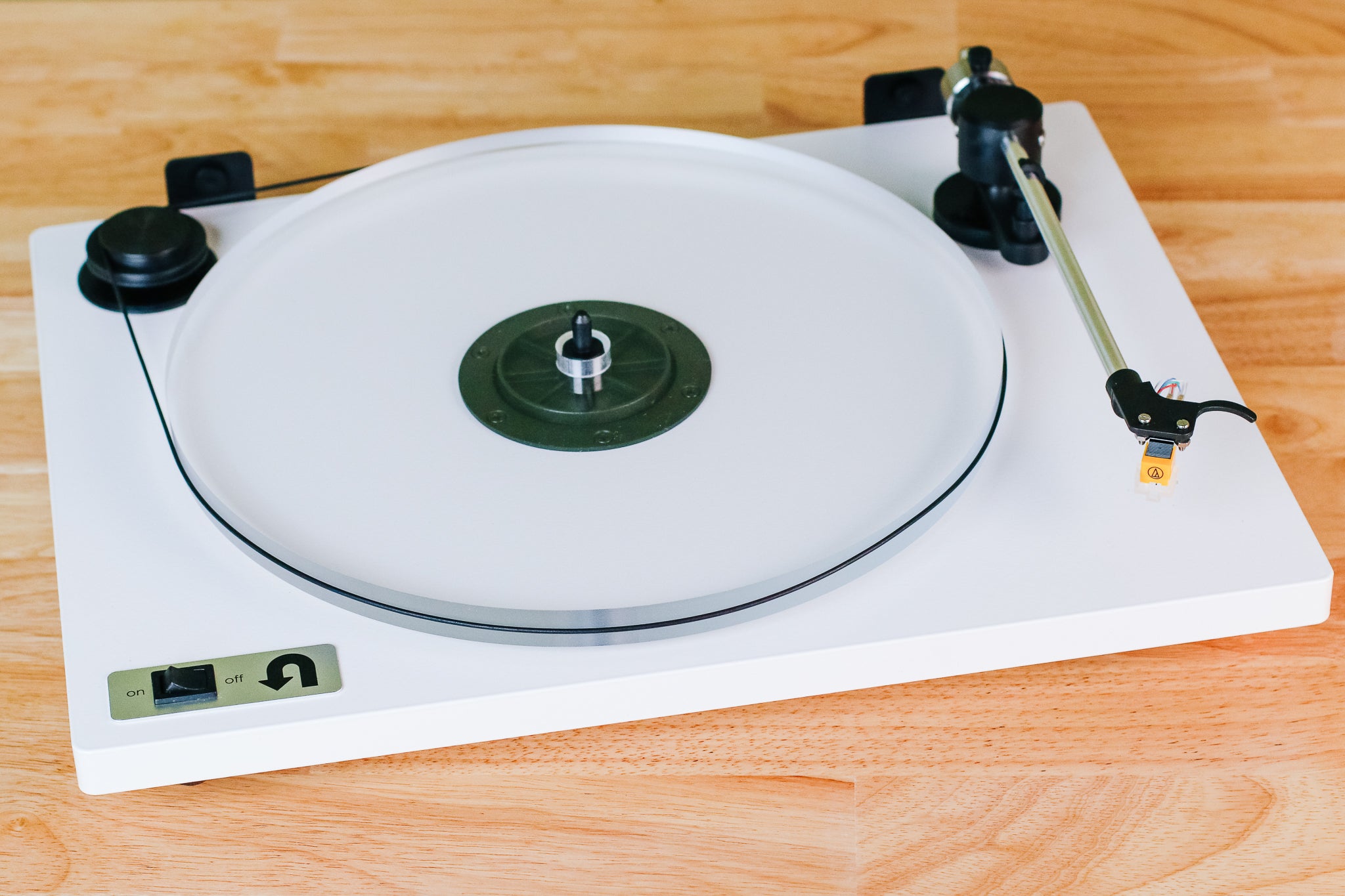 The U-Turn Orbit Basic record player, shown on a wooden surface.