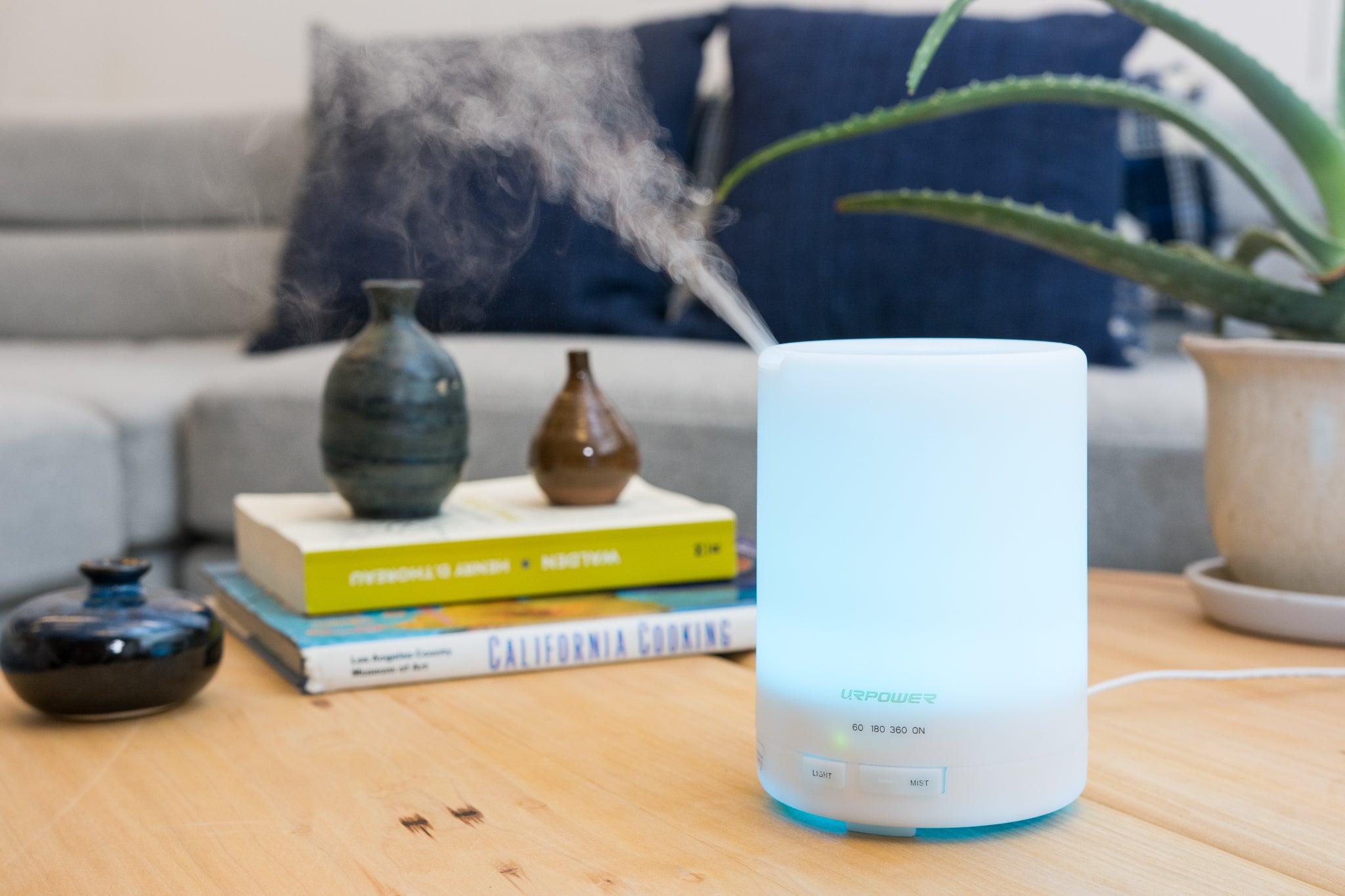 An Urpower essential oil diffuser, shown on a coffee table.